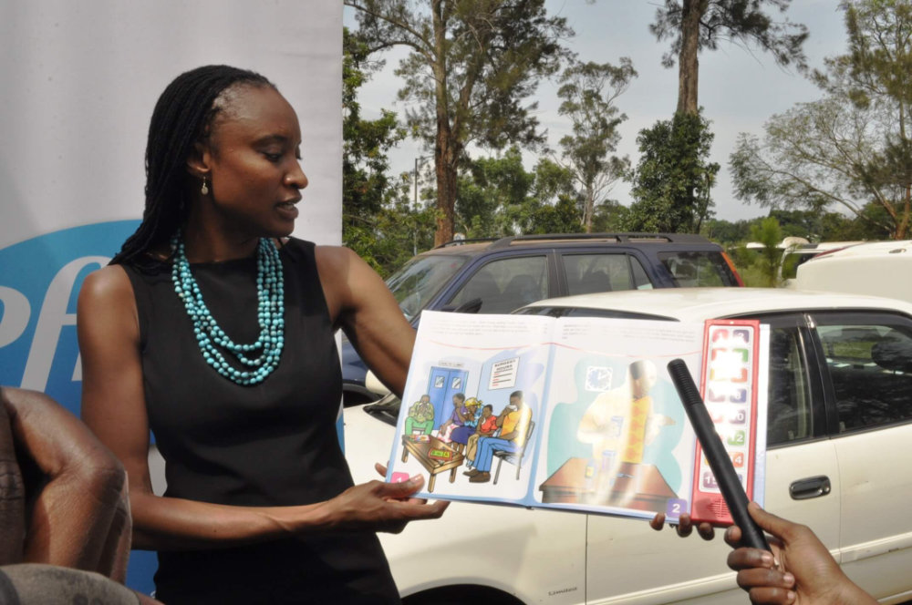 A woman presents a Speaking Book to promote good health information.
